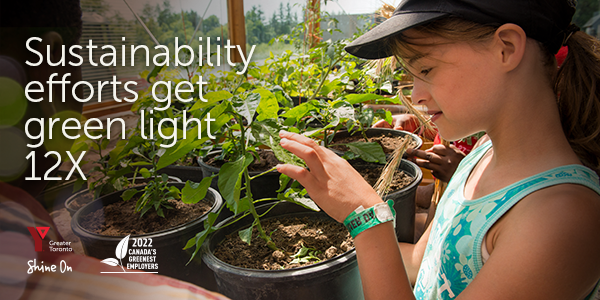Text: Sustainability efforts get green light 12X Photos: Child gently touches a seedling in a nursery pot.