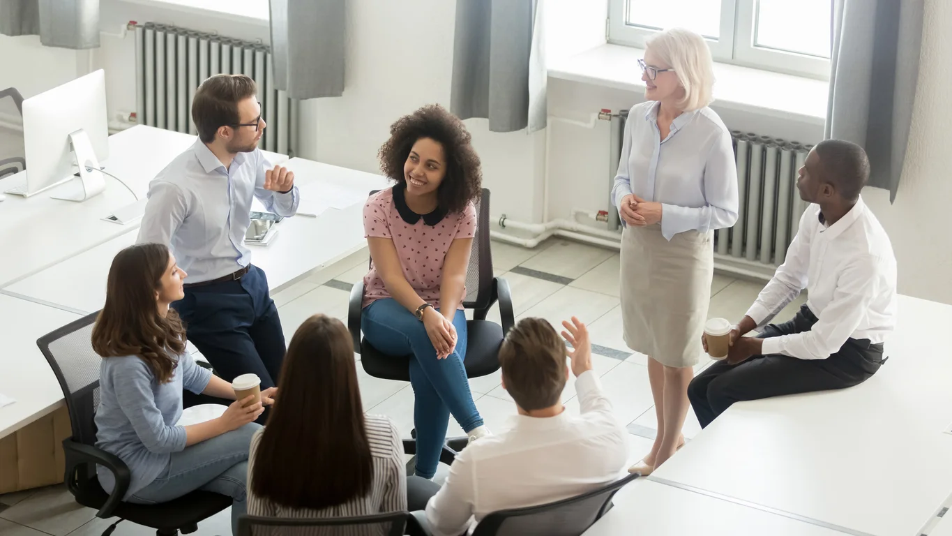 Business people group discussing work plan with coach at meeting stock photo