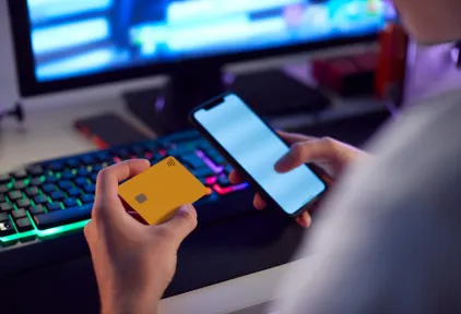 Close Up Of Person With Addiction To Online Gambling Or Shopping Using Credit Card And Mobile Phone stock photo