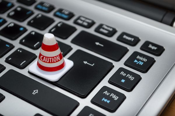 computer keyboard with a caution sign replacing the Enter key