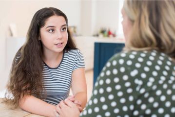 a female youth talking with a woman