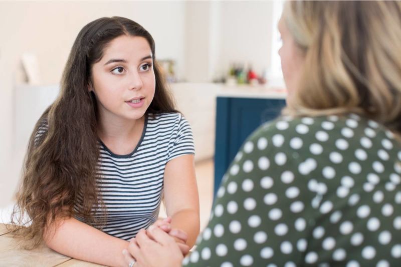 une jeune fille en train de discuter avec une femme