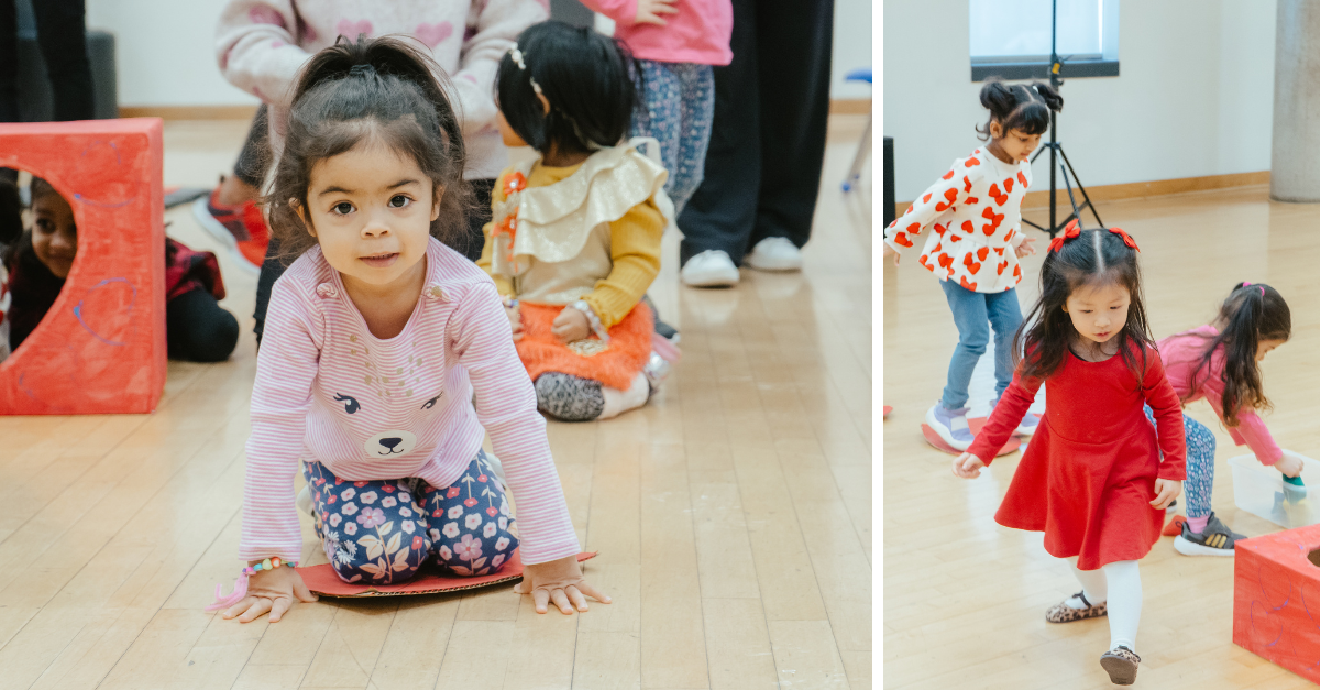 Children play and move through a Valentine’s Day–themed obstacle course set up in a gym.
