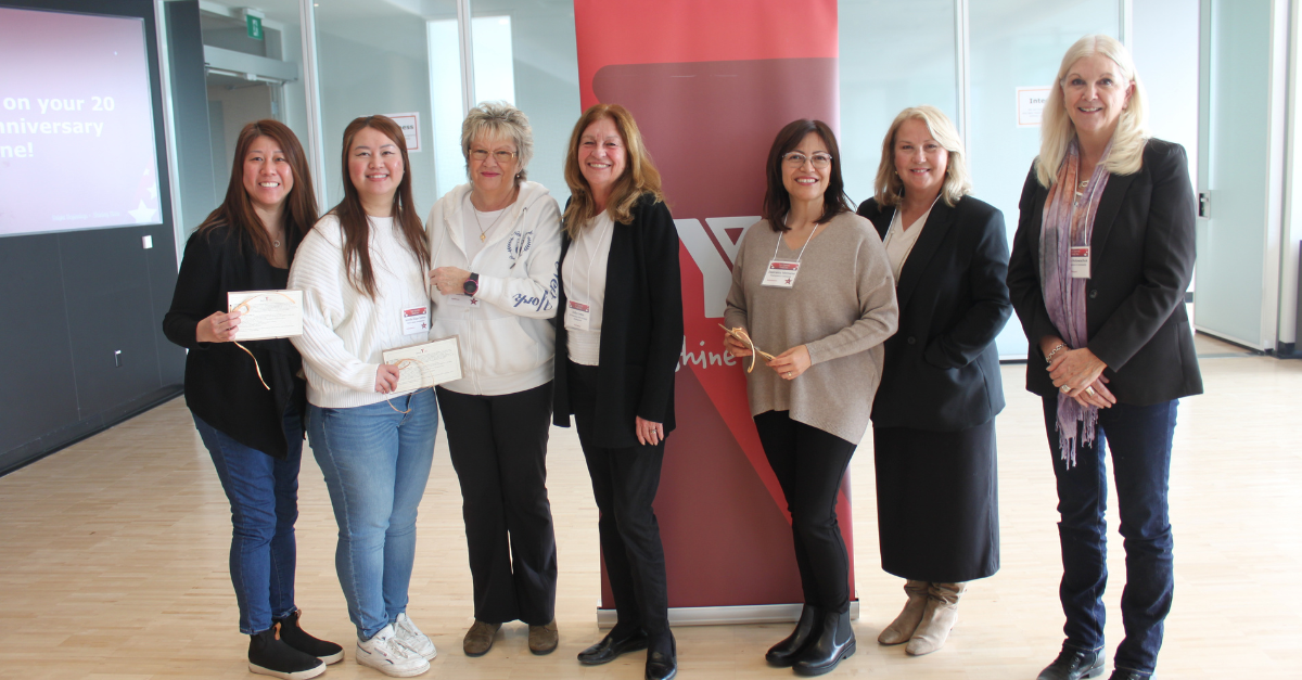 Jennifer stands with YMCA of Greater Toronto team members, including President and CEO Lesley Davidson, at the Shining Stars and Bright Beginnings event where she is recognized for her years of service.
