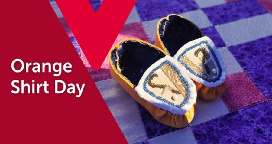 Text: Orange Shirt Day. Image: A pair of small, embroidered moccasins on a patchwork quilt.