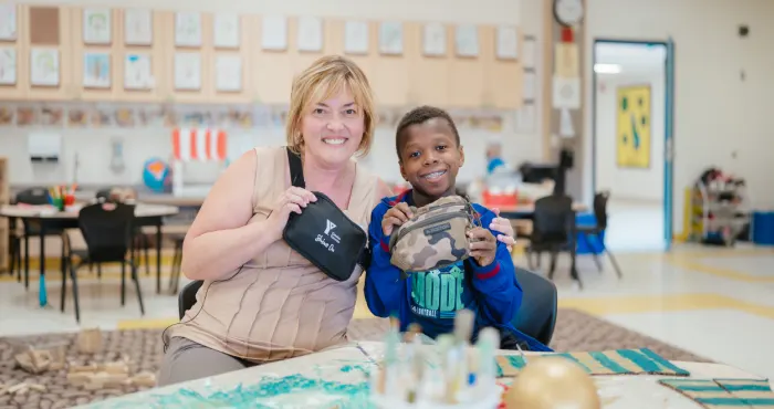 What do YMCA Before & After School educators carry to help keep children safe?