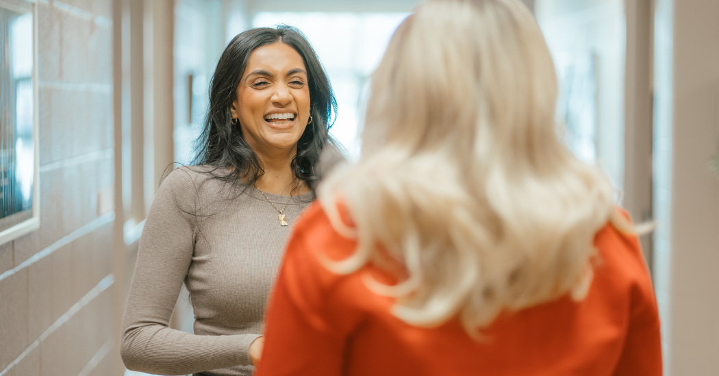 Vanessa speaks with Susan in a YMCA hallway.