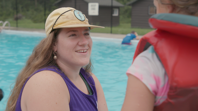 staff sitting by the pool