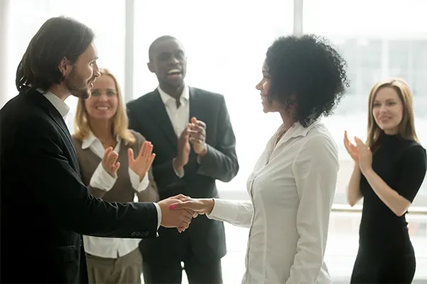 a group of professionals networking, shaking hands