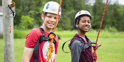 two boys read to go on the high ropes