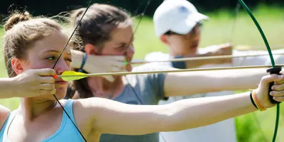 a girl climbing up the high ropes