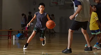 A youth playing basketball at the YMCA.