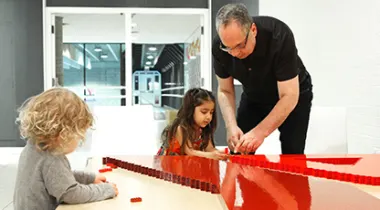 Medhat Mahdy helps children build a Y with building blocks