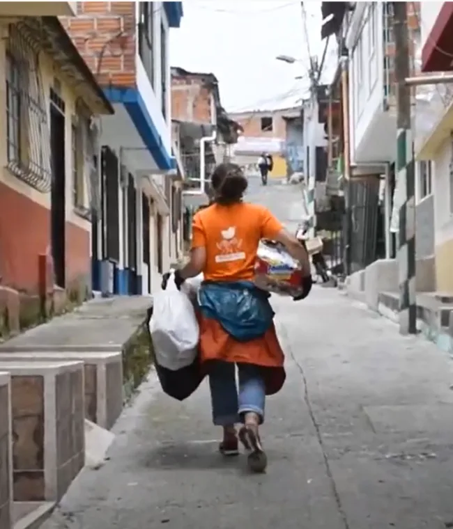 person walking down a street, holding bags in Risaralda Colombia