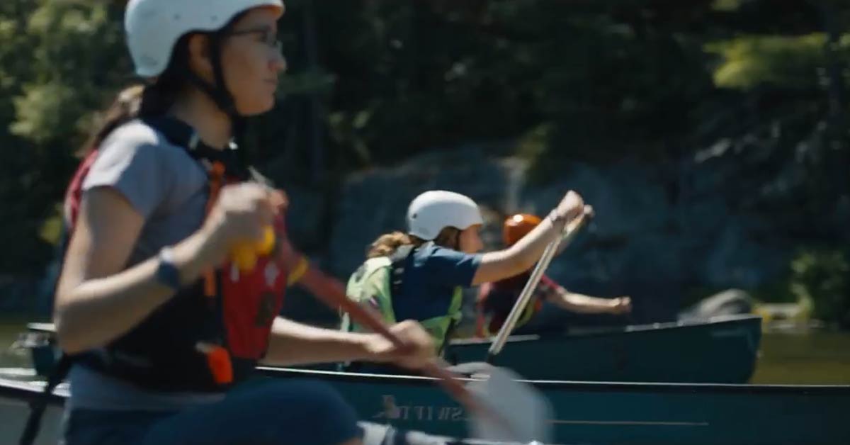 Girl with canoe going to the lake