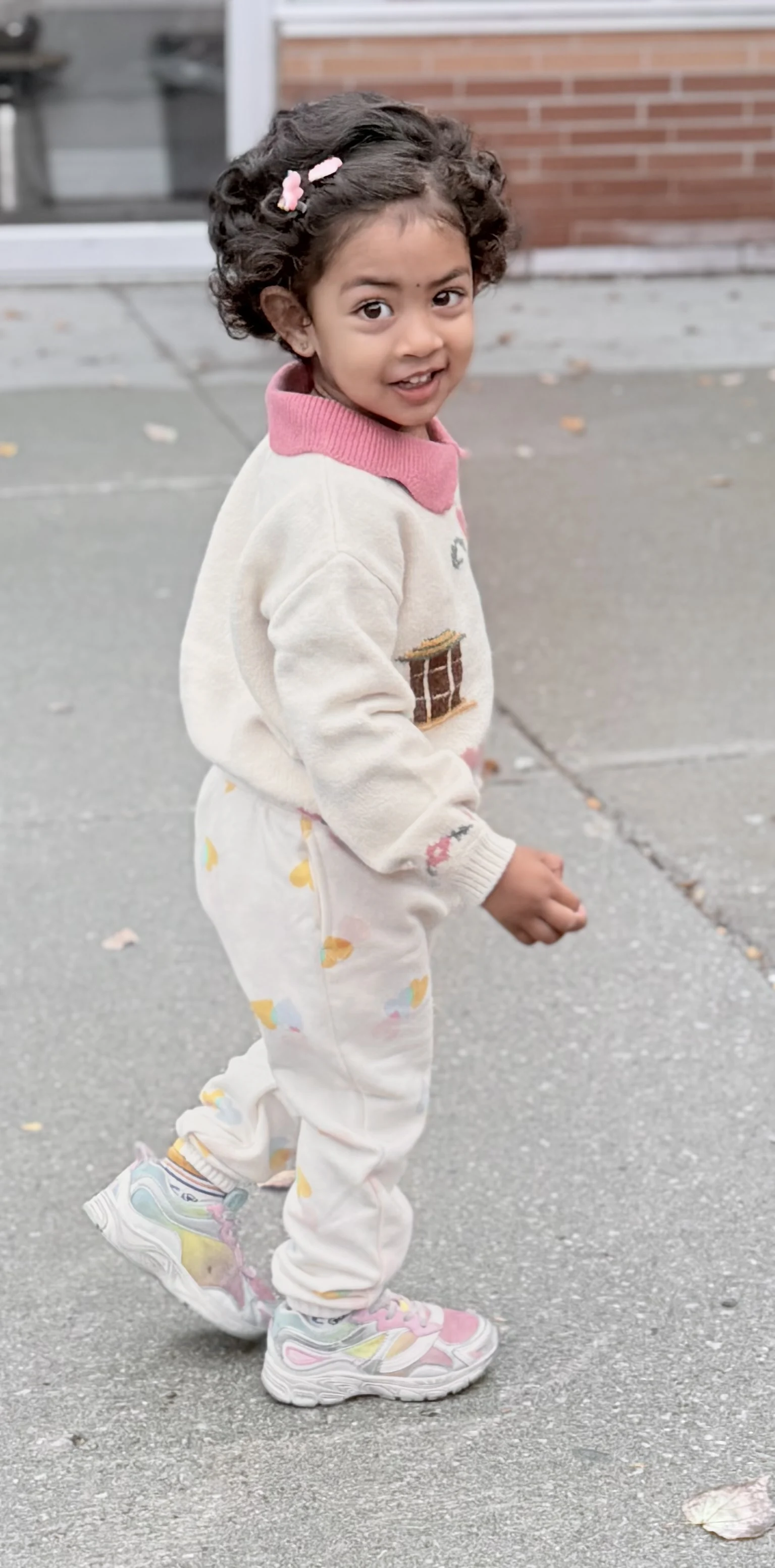 A smiling child plays in a school yard