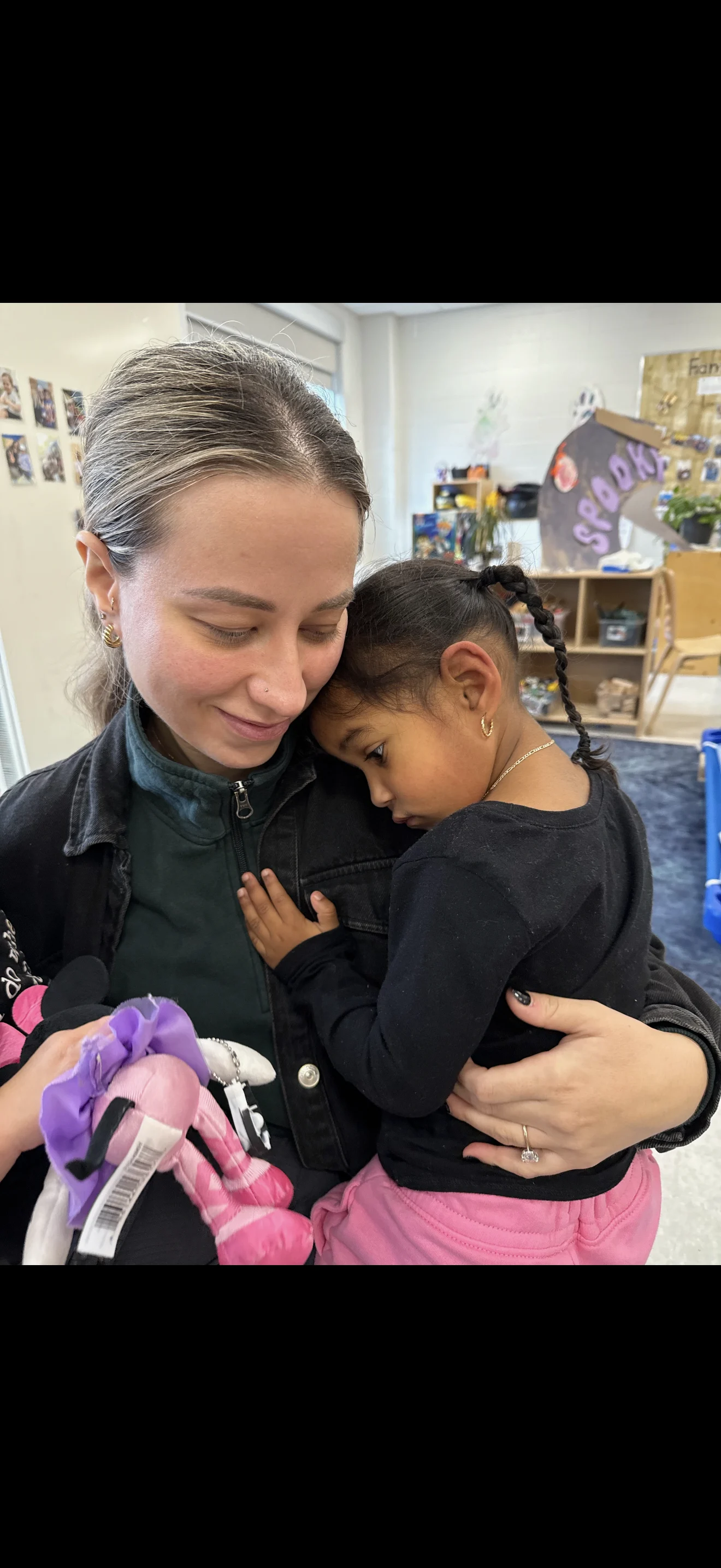 A child and an adult hug.