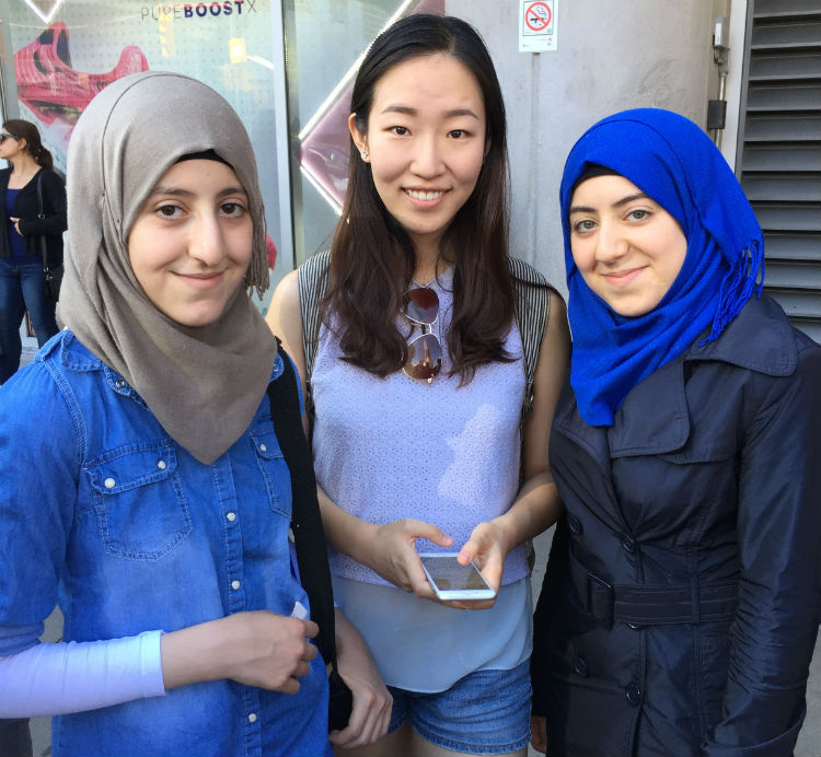 three teenage girls with phone