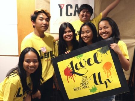 Hera with YCAN group members holding up sign that says Level Up