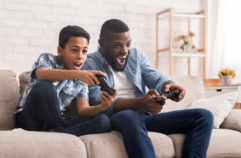 Child playing video game with a parent