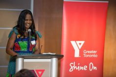 Omoteniola Swodumila speaks at the podium after receiving the 2023 Outstanding Black Achiever of the Year Award.